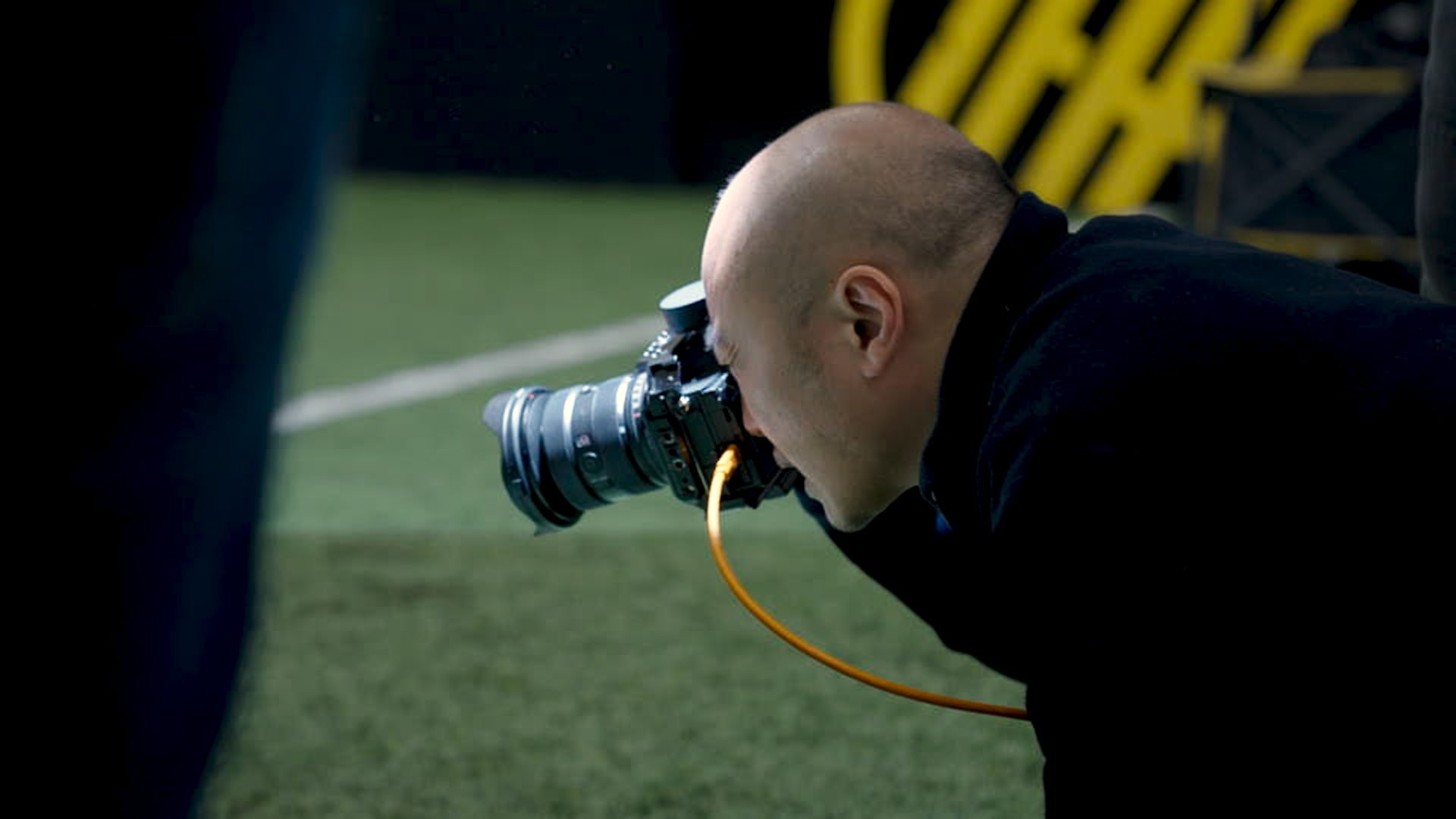 Photographer shooting low on the pitch at the Martinez shoot